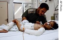 Lebanese Sobhi Abbas, top, comforts his son Abbas Abbas, 6-years-old, who was injured while playing with a cluster bomb in Blida, on Saturday August 26, 2006&nbsp; 